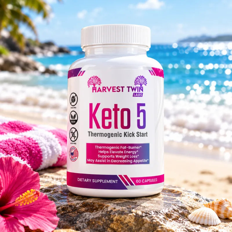 A bottle of Harvest Twin Keto 5 dietary supplement capsules placed on a beach rock with a pink towel, hibiscus flower, and seashells in the foreground, and a sunny ocean beach background.