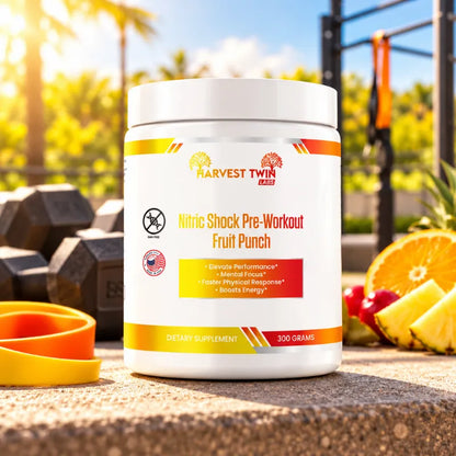 A white tub of Harvest Twin Labs Nitric Shock Pre-Workout Fruit Punch dietary supplement sits on a stone surface outdoors, with dumbbells, a yellow wristband, and sliced orange and pineapple in the background.