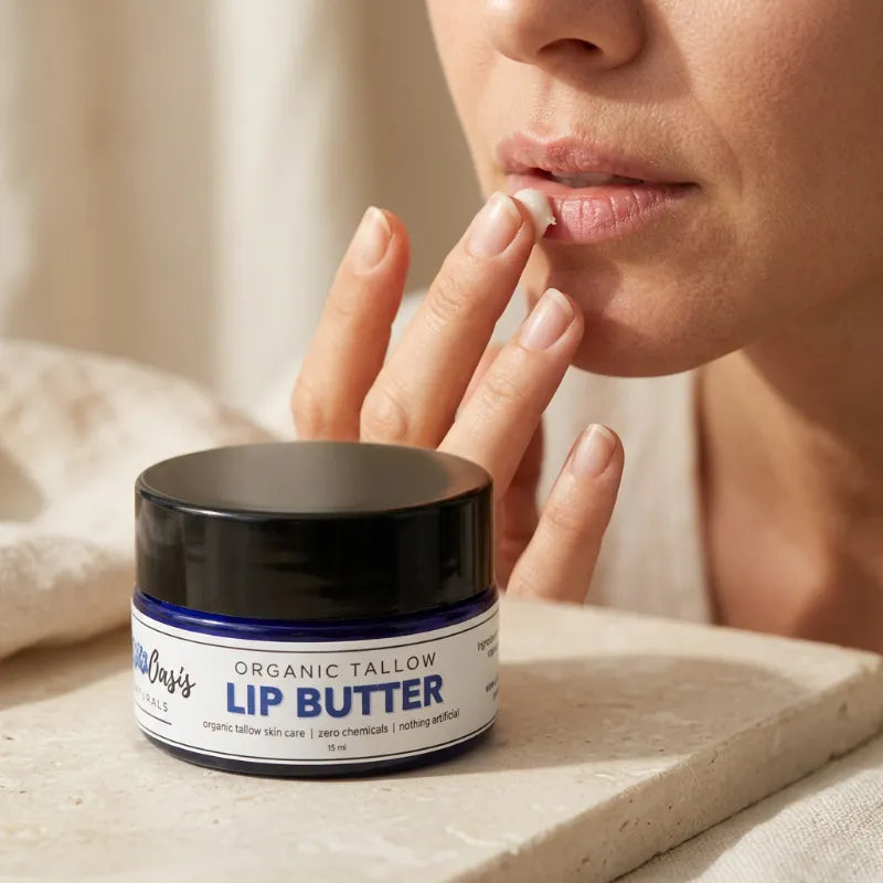 A close-up lifestyle shot of a person applying or tasting lip butter from a jar labeled 'Wife's Organic Tallow Lip Butter' on a stone surface.
