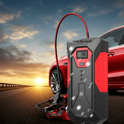 Portable car jump starter on road with red vehicle at sunset, outdoor emergency tool
